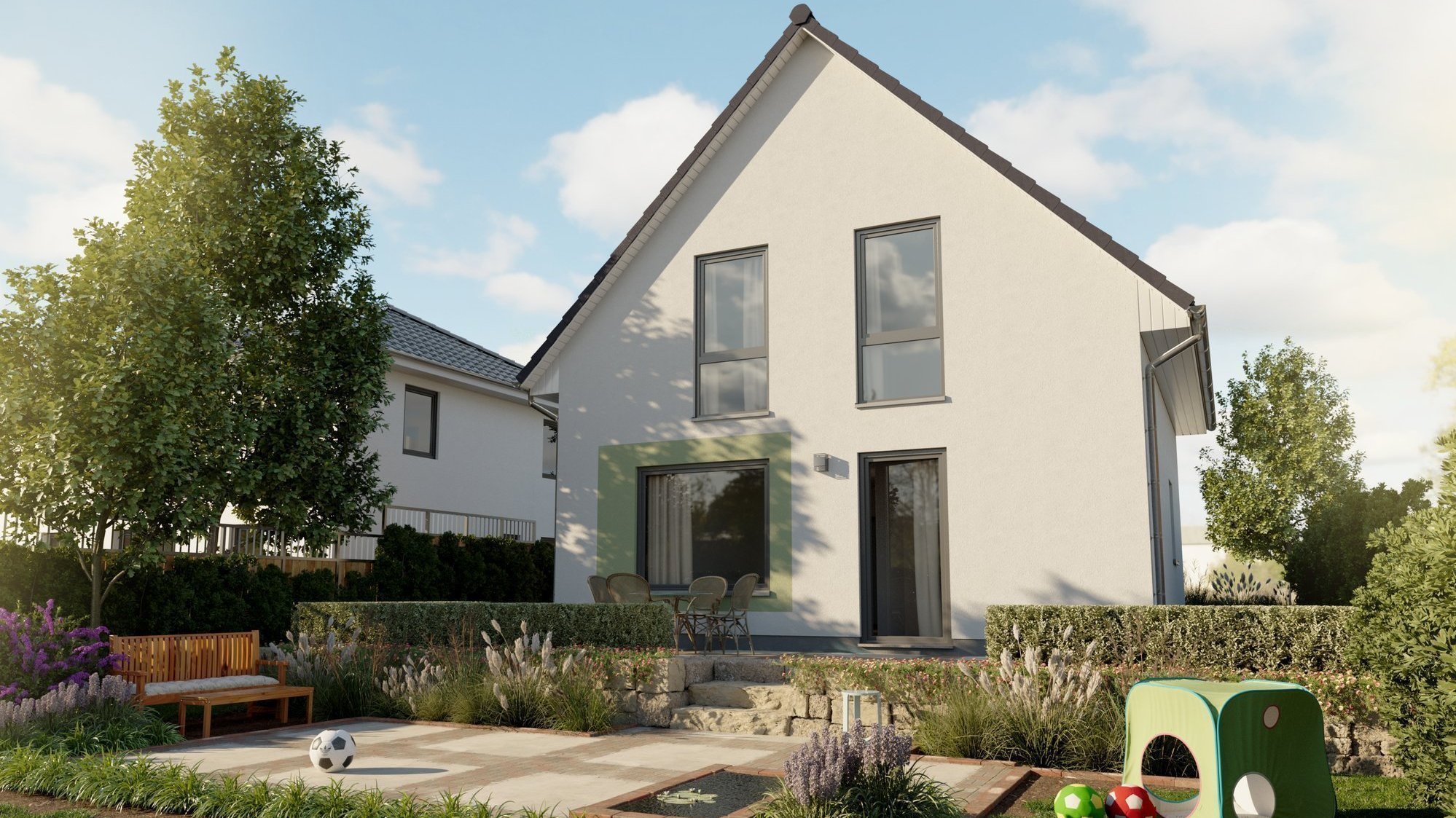 Modernes Einfamilienhaus mit großem Garten und Terrasse; im Vordergrund Spielbereich im Grünen.