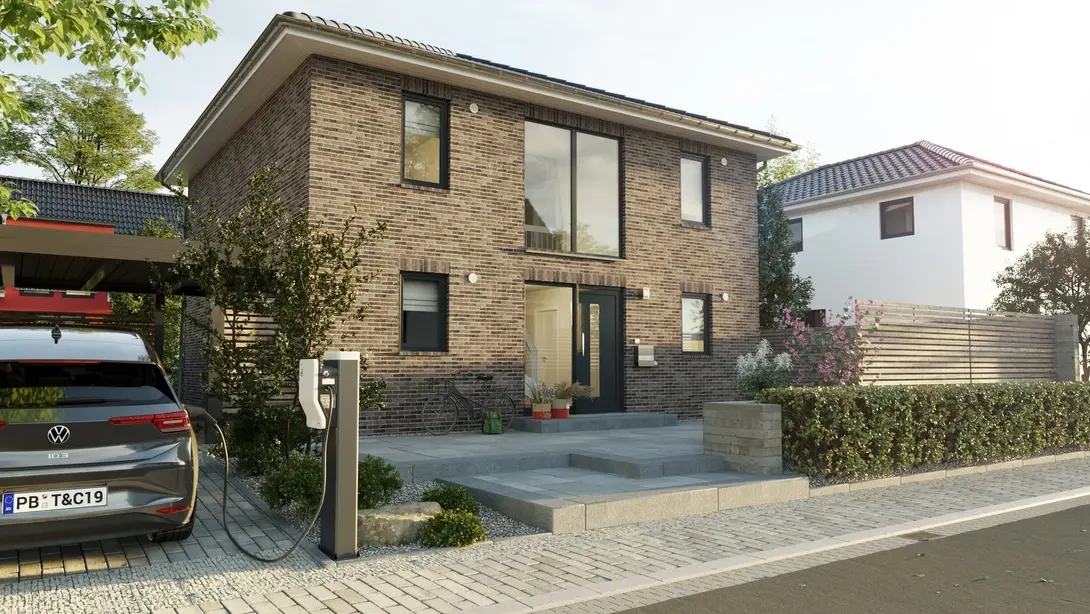 Modernes Klinkerhaus in Massivbauweise Modernes zweigeschossiges Einfamilienhaus mit Klinkerfassade, großem Eingangsbereich und Carport – Massivhaus von Thielker MassivHaus