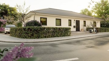 Moderner Bungalow im Landkreis Emsland bauen mit Thielker MassivHaus Moderner Bungalow mit heller Fassade, Flachdach, Hecke und Vorgarten im Landkreis Emsland