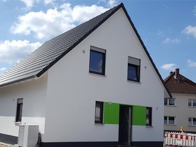 Modernes Einfamilienhaus mit weißer Putzfassade und Satteldach – Massivhaus von Thielker MassivHaus