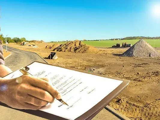 Grundstück sichern und Hausbau starten Person unterschreibt Bauvertrag auf einer Baustelle mit Baugrundstück im Hintergrund – Symbolbild für Grundstückskauf und Hausbauplanung.